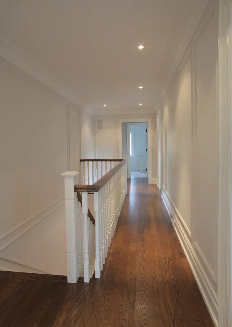 Long upstairs hallway with wide-plank hardwood floor