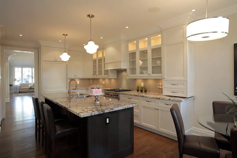 Classic white kitchen with glass-front cabinets and dark island