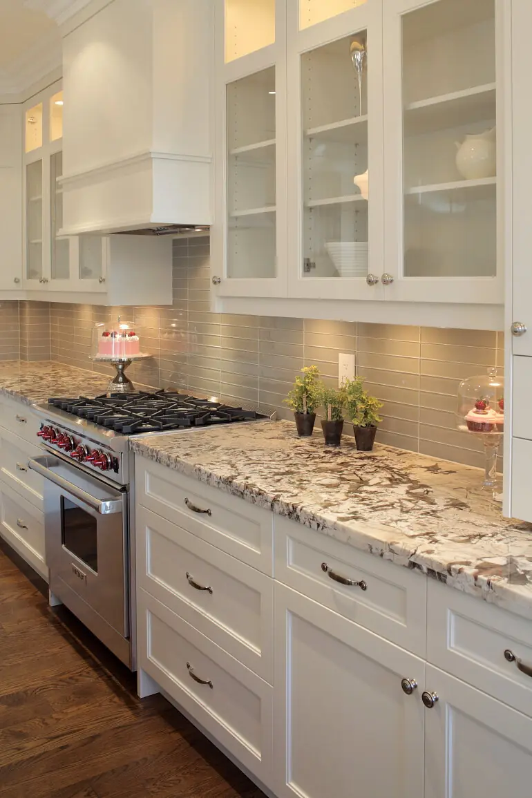 Glass-front upper cabinets above a granite counter