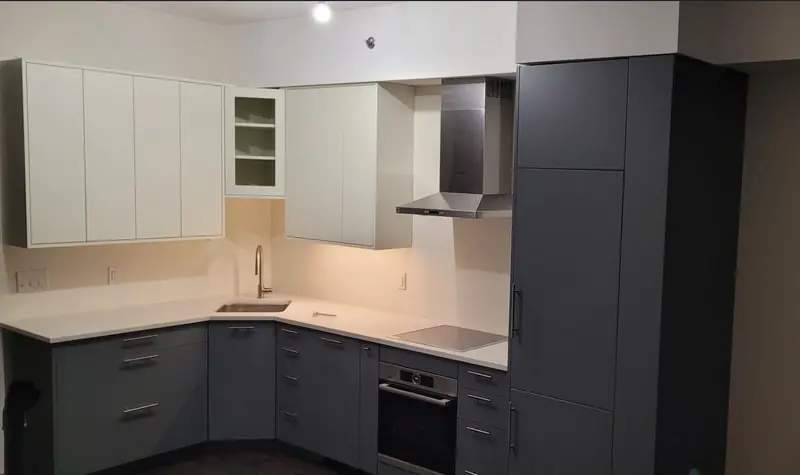 Two-tone kitchen with white upper and charcoal lower cabinets