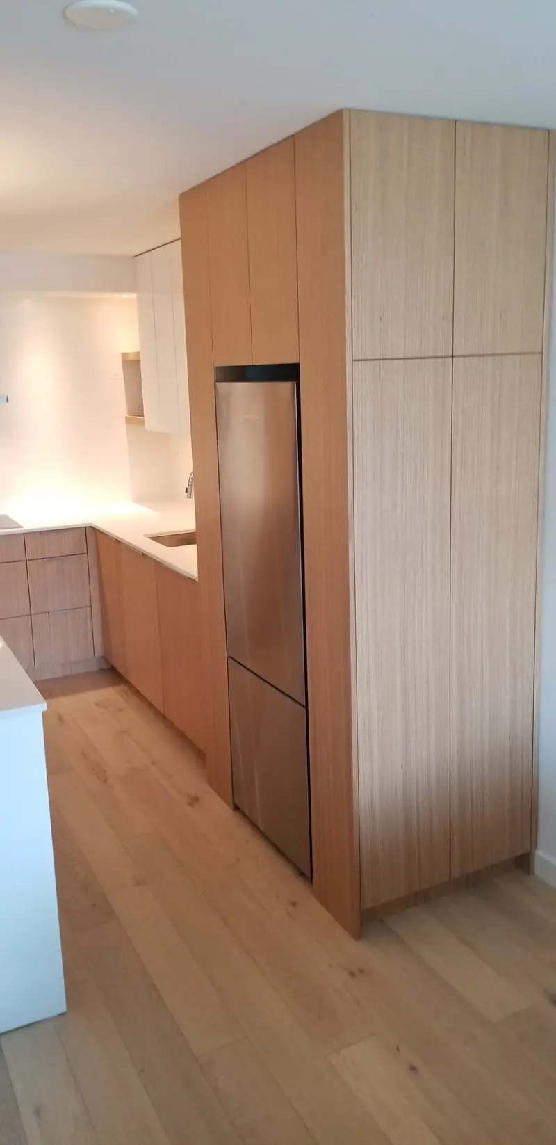 Wood-veneer wall of full-height cabinetry