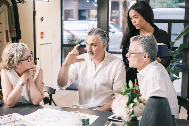The Studio 955 team reviewing ideas together at the studio table