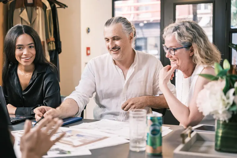 Sinisa Pajic and the Studio 955 team reviewing plans with clients at the studio table